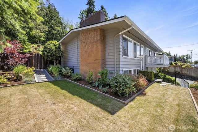 21240 15th Ave S, Des Moines, WA 98198 - view of property exterior with a chimney and brick siding