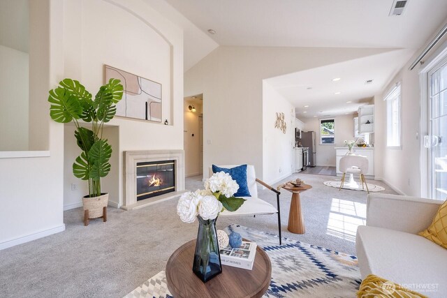 4121 248th Ct SE Unit 45, Sammamish, WA 98029 - living area featuring carpet floors, a glass covered fireplace, and lofted ceiling