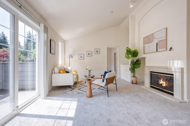4121 248th Ct SE Unit 45, Sammamish, WA 98029 - living area with carpet flooring, vaulted ceiling, and a glass covered fireplace