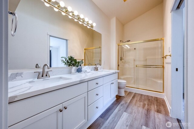 4121 248th Ct SE Unit 45, Sammamish, WA 98029 - full bathroom featuring double vanity, wood finished floors, a stall shower, and vaulted ceiling