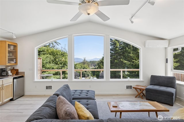 7773 Hideaway Ln, Anacortes, WA 98221 - living room with rail lighting, a wall unit AC, healthy amount of natural light, a mountain view, and vaulted ceiling