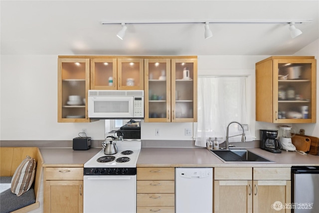 7773 Hideaway Ln, Anacortes, WA 98221 - kitchen with white appliances, rail lighting, light brown cabinetry, light countertops, and glass insert cabinets