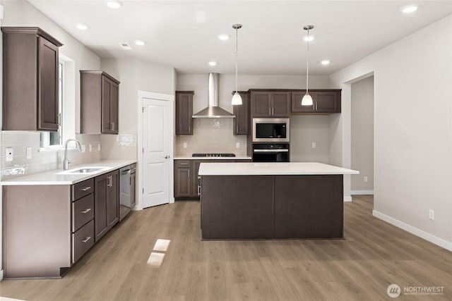 4043 98th Avenue Ct E Unit 24, Edgewood, WA 98371 - kitchen with black appliances, wall chimney exhaust hood, dark brown cabinetry, decorative backsplash, and recessed lighting