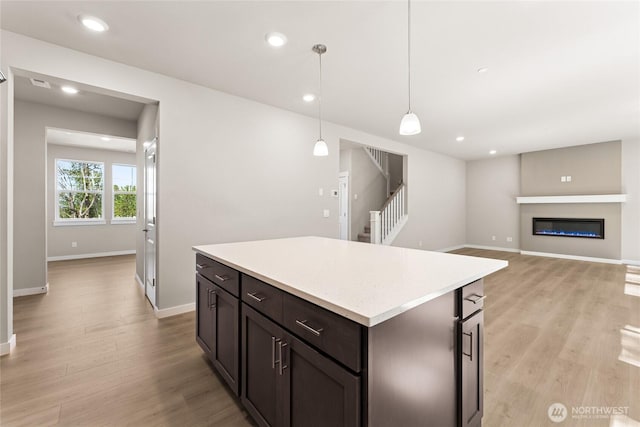 4043 98th Avenue Ct E Unit 24, Edgewood, WA 98371 - kitchen with light countertops, light wood-style flooring, a center island, pendant lighting, and recessed lighting