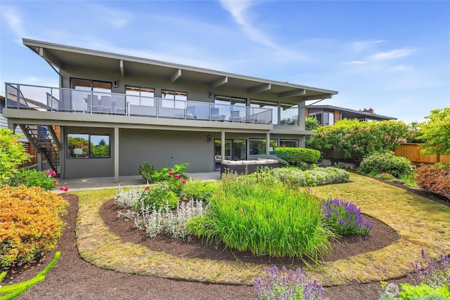8751 Jones Ave NW, Seattle, WA 98117 - rear view of house featuring stairs, a patio area, and a balcony