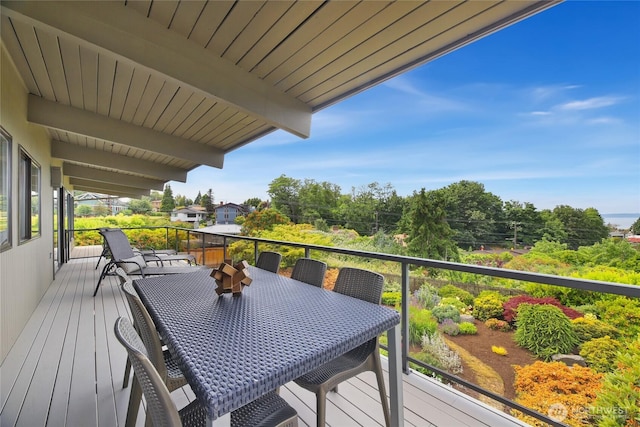 8751 Jones Ave NW, Seattle, WA 98117 - wooden deck featuring outdoor dining space and view of scattered trees