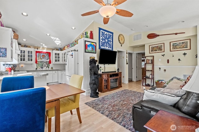 231 Benton, Leavenworth, WA 98826 - living room featuring vaulted ceiling, ceiling fan, light wood-type flooring, a fireplace, and recessed lighting