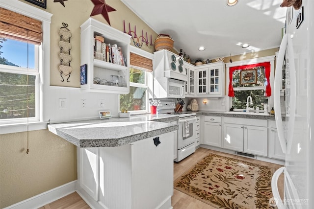 231 Benton, Leavenworth, WA 98826 - kitchen featuring white appliances, plenty of natural light, glass insert cabinets, white cabinets, and recessed lighting