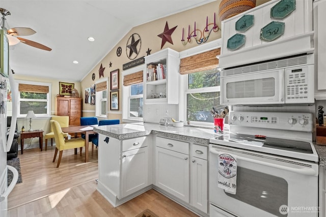 231 Benton, Leavenworth, WA 98826 - kitchen featuring white appliances, vaulted ceiling, light wood finished floors, plenty of natural light, and a peninsula