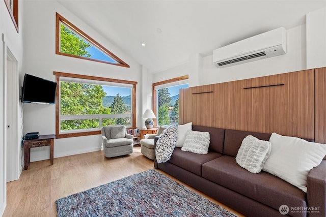 231 Benton, Leavenworth, WA 98826 - living room with a wall unit AC, high vaulted ceiling, light wood-type flooring, and plenty of natural light