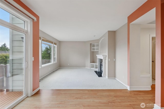 3301 Monterey Ct NE, Renton, WA 98056 - unfurnished living room with wood finished floors, a fireplace with flush hearth, and carpet