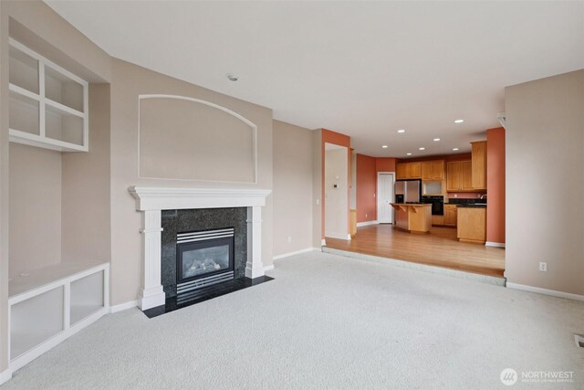 3301 Monterey Ct NE, Renton, WA 98056 - unfurnished living room featuring light colored carpet, a tiled fireplace, and recessed lighting