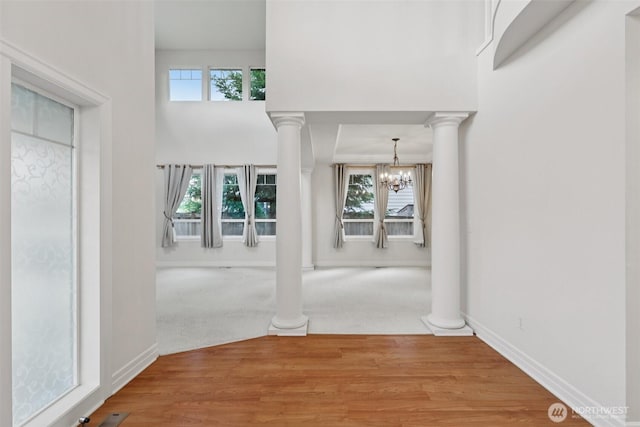 3301 Monterey Ct NE, Renton, WA 98056 - entrance foyer featuring healthy amount of natural light, a chandelier, and ornate columns