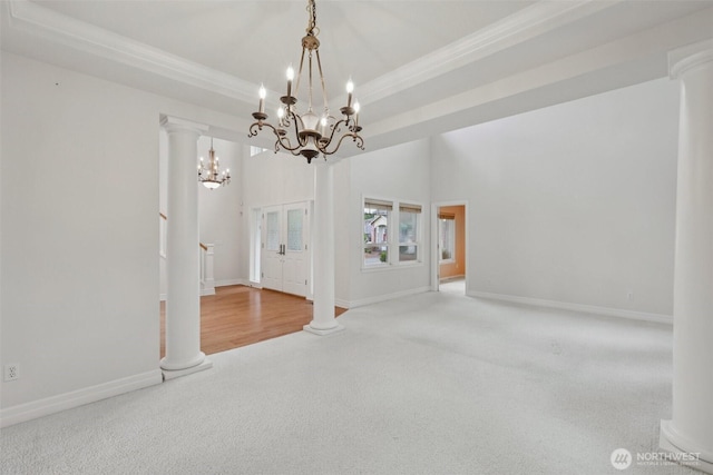 3301 Monterey Ct NE, Renton, WA 98056 - spare room with ornamental molding, a chandelier, carpet floors, stairway, and ornate columns