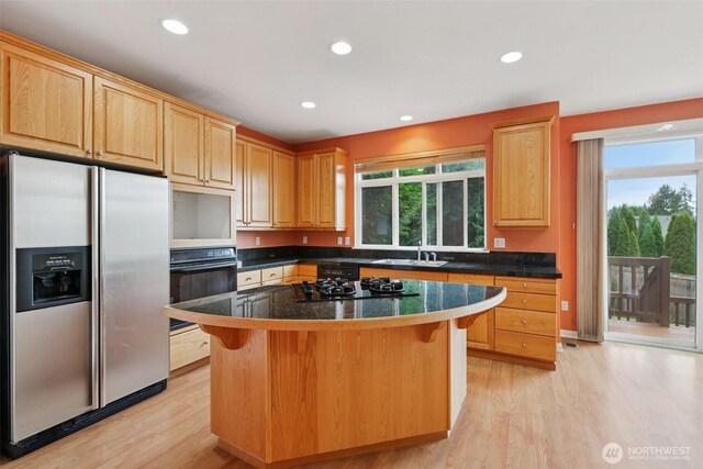 3301 Monterey Ct NE, Renton, WA 98056 - kitchen featuring black appliances, light wood finished floors, light brown cabinets, recessed lighting, and a breakfast bar area