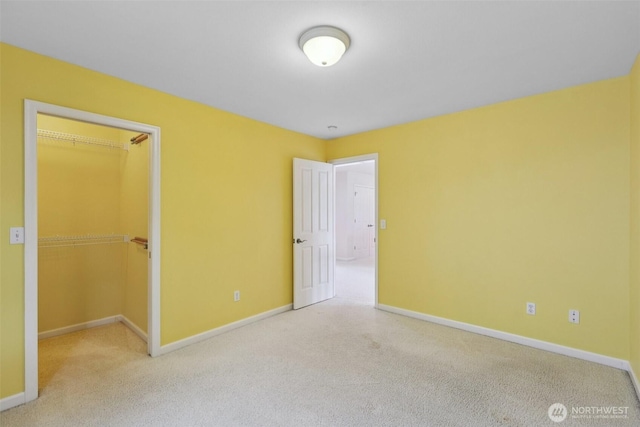 3301 Monterey Ct NE, Renton, WA 98056 - unfurnished bedroom with carpet, a walk in closet, and a closet