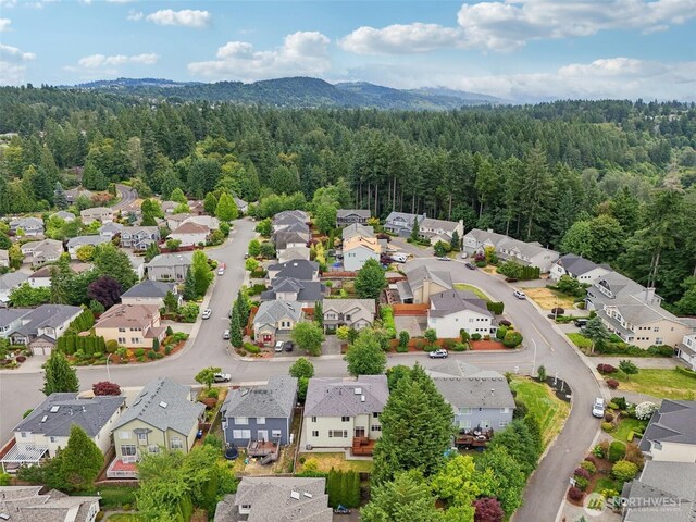 3301 Monterey Ct NE, Renton, WA 98056 - aerial perspective of suburban area featuring a heavily wooded area and mountains