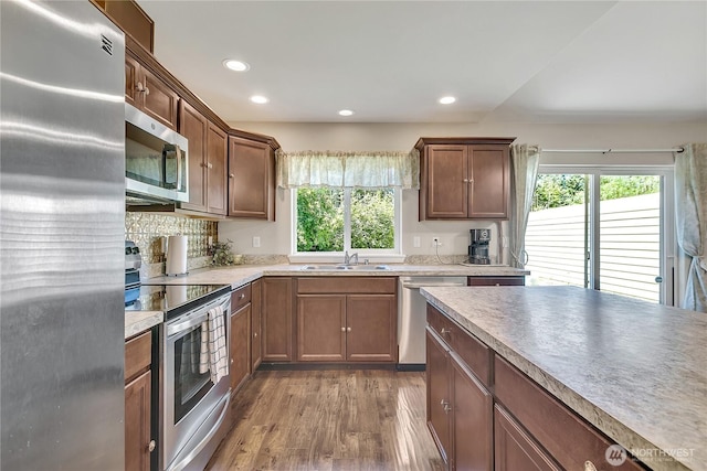 19802 69th Avenue Ct E, Spanaway, WA 98387 - kitchen featuring stainless steel appliances, healthy amount of natural light, wood finished floors, recessed lighting, and light countertops