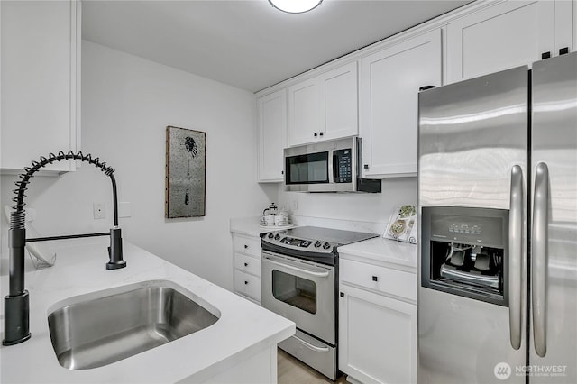 1835 S 286th Ln Unit R201, Federal Way, WA 98003 - kitchen with stainless steel appliances, light countertops, and white cabinets