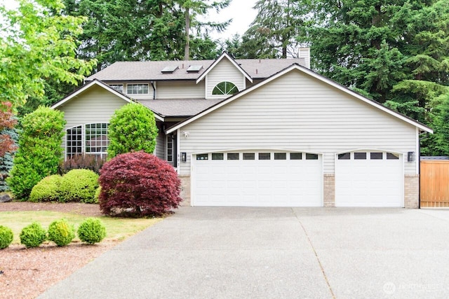 903 198th Ave E, Lake Tapps, WA 98391 - traditional-style house with a garage, concrete driveway, a chimney, and roof with shingles