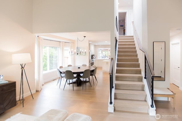 903 198th Ave E, Lake Tapps, WA 98391 - stairway featuring wood finished floors and a chandelier