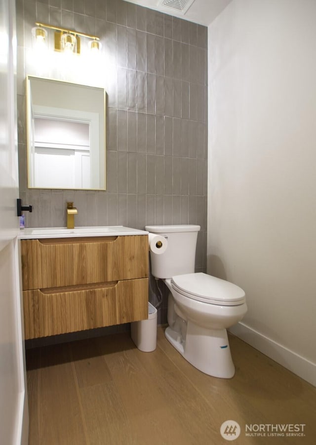 903 198th Ave E, Lake Tapps, WA 98391 - half bathroom featuring tile walls, wood finished floors, and vanity