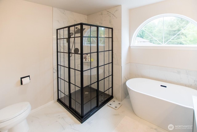 903 198th Ave E, Lake Tapps, WA 98391 - bathroom with marble look tiles, a stall shower, and a freestanding tub