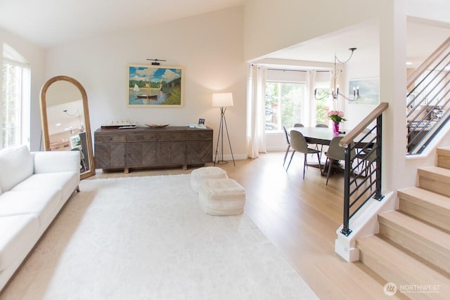 903 198th Ave E, Lake Tapps, WA 98391 - living room featuring wood finished floors, stairway, a chandelier, and lofted ceiling