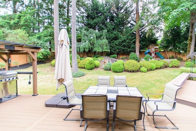 903 198th Ave E, Lake Tapps, WA 98391 - view of patio / terrace with a wooden deck, a playground, area for grilling, and outdoor dining space