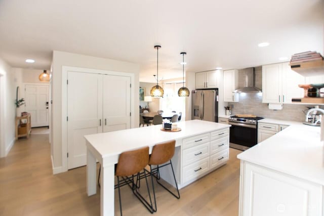 903 198th Ave E, Lake Tapps, WA 98391 - kitchen with stainless steel appliances, wall chimney exhaust hood, light countertops, white cabinets, and backsplash