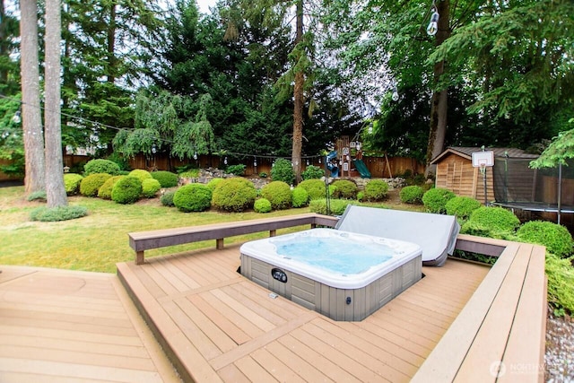 903 198th Ave E, Lake Tapps, WA 98391 - wooden terrace with a fenced backyard, a covered hot tub, a playground, a trampoline, and a shed