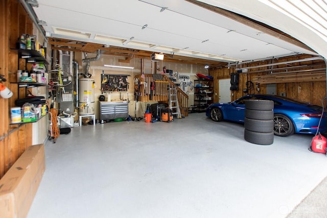 903 198th Ave E, Lake Tapps, WA 98391 - garage featuring strapped water heater, a workshop area, and a garage door opener