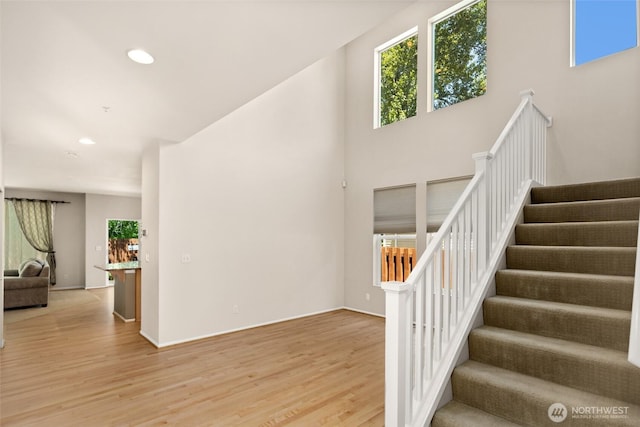 21609 46th Pl S Unit 95, Kent, WA 98032 - stairway featuring wood finished floors, healthy amount of natural light, recessed lighting, and a towering ceiling