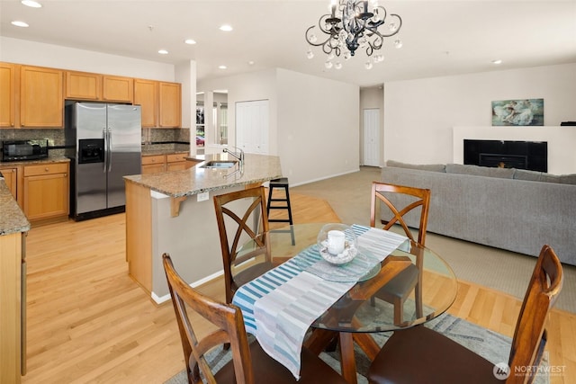21609 46th Pl S Unit 95, Kent, WA 98032 - dining room with recessed lighting, light wood-type flooring, a chandelier, and a fireplace