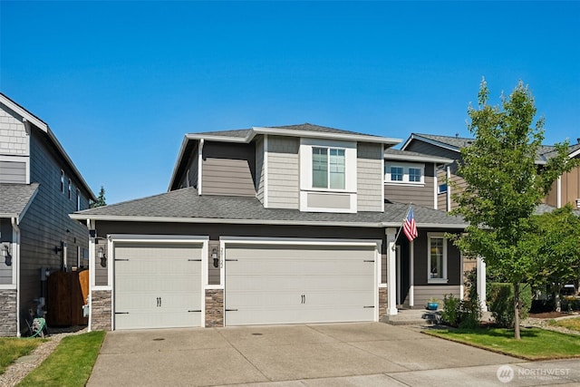 20122 18th Avenue Ct E, Spanaway, WA 98387 - view of front of property with concrete driveway, stone siding, roof with shingles, and a garage