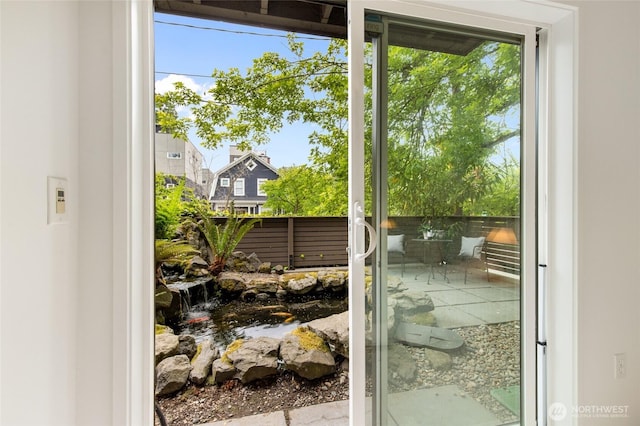 201 20th Ave E, Seattle, WA 98112 - doorway to outside featuring a small pond and healthy amount of natural light