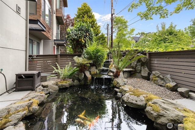 201 20th Ave E, Seattle, WA 98112 - fenced backyard featuring a small pond