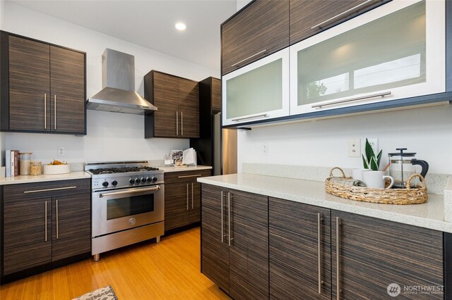 201 20th Ave E, Seattle, WA 98112 - kitchen with high end stove, wall chimney range hood, modern cabinets, dark brown cabinets, and recessed lighting