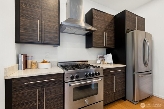 201 20th Ave E, Seattle, WA 98112 - kitchen featuring stainless steel appliances, ventilation hood, dark brown cabinetry, light countertops, and light wood-style flooring
