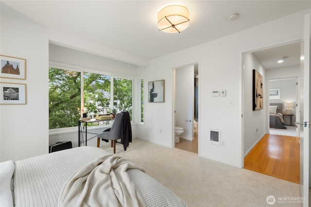 201 20th Ave E, Seattle, WA 98112 - bedroom with light colored carpet, connected bathroom, and heating unit