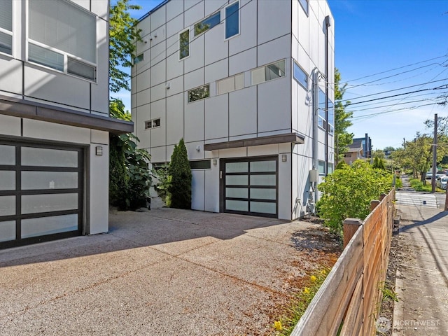 733 Martin Luther King Jr Way, Seattle, WA 98144 - view of building exterior featuring a garage and concrete driveway