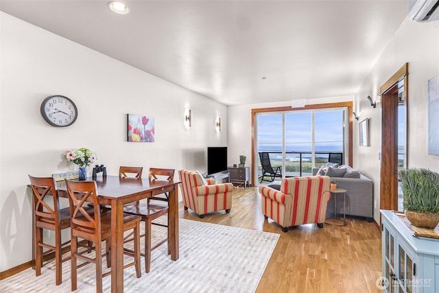 7714 Birch Bay Dr Unit 203, Blaine, WA 98230 - dining area with a wall mounted AC and light wood finished floors
