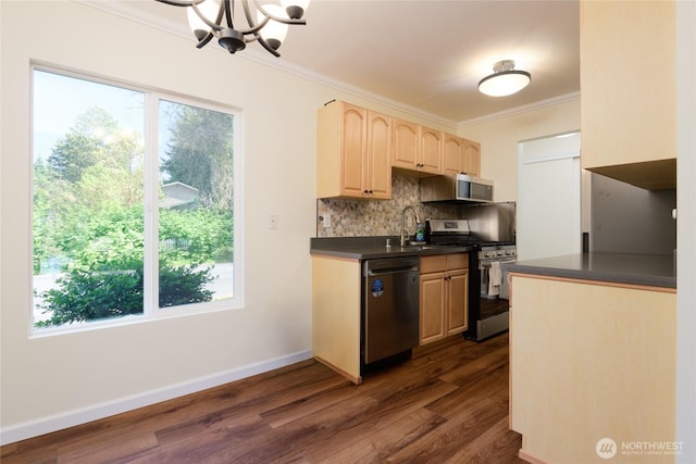 5029 84th St SW Unit 301, Mukilteo, WA 98275 - kitchen featuring stainless steel appliances, dark countertops, a chandelier, crown molding, and tasteful backsplash