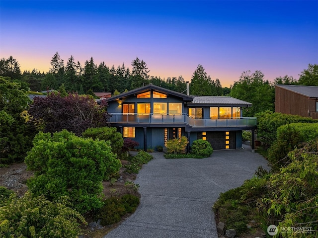 9882 Manitou Beach Dr NE, Bainbridge Island, WA 98110 - contemporary house featuring a balcony, a garage, driveway, and a metal roof