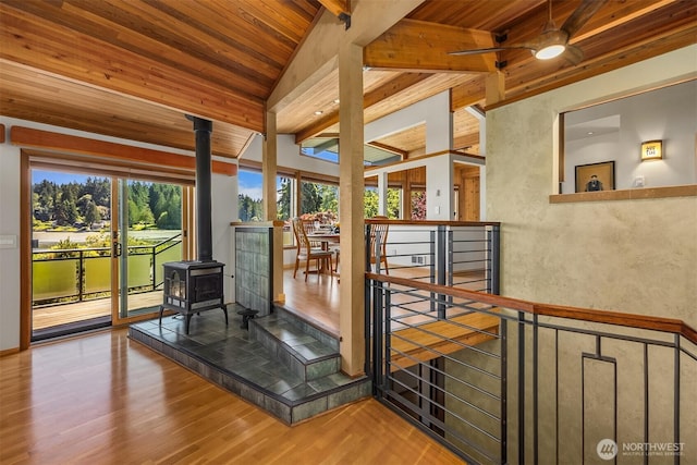 9882 Manitou Beach Dr NE, Bainbridge Island, WA 98110 - stairs with a wood stove, wooden ceiling, wood finished floors, and a ceiling fan