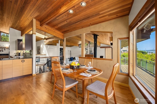 9882 Manitou Beach Dr NE, Bainbridge Island, WA 98110 - dining room with wood ceiling, wood finished floors, and a wood stove