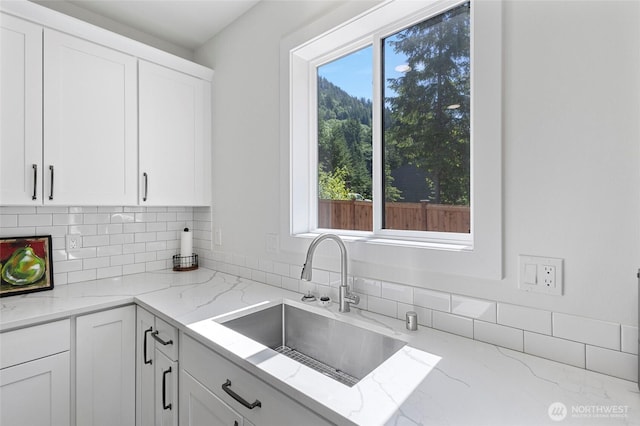 7952 Apache Dr, Maple Falls, WA 98266 - kitchen featuring decorative backsplash, white cabinets, and light stone countertops