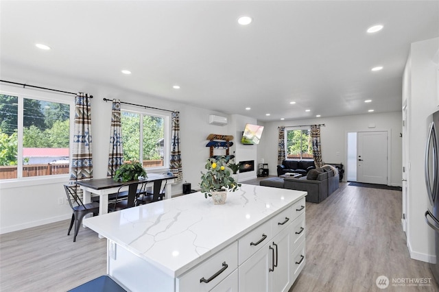 7952 Apache Dr, Maple Falls, WA 98266 - kitchen with healthy amount of natural light, light wood-style floors, recessed lighting, white cabinets, and a kitchen island