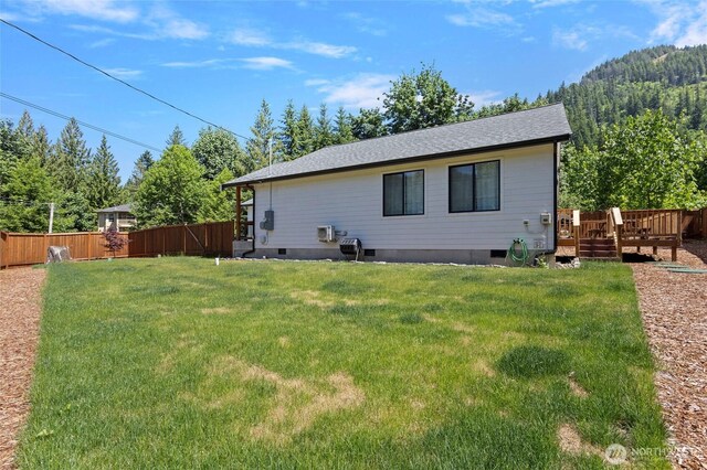 7952 Apache Dr, Maple Falls, WA 98266 - rear view of house featuring a fenced backyard, a wooden deck, crawl space, and a shingled roof