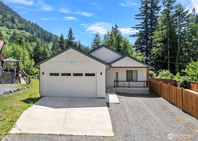 7952 Apache Dr, Maple Falls, WA 98266 - view of front of house featuring driveway, an attached garage, and a view of trees